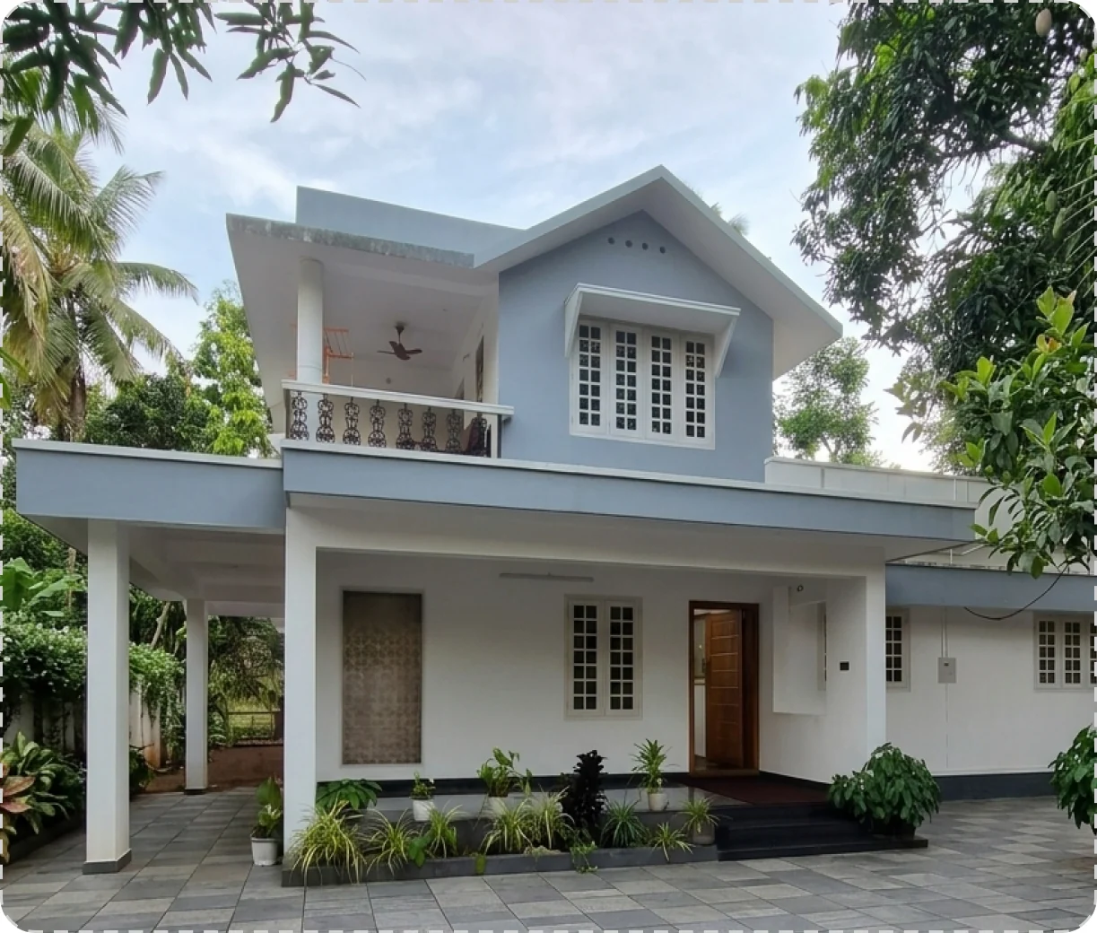 House 14 — two-storey residence with a tiled roof and white columns